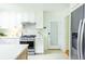 Well-lit kitchen with white cabinetry, stainless steel appliances, and herringbone wood floors at 1662 Rainier Falls Ne Dr, Atlanta, GA 30329