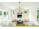 Bright living room featuring a cozy fireplace, modern chandelier, neutral colors, and stylish furnishings at 1662 Rainier Falls Ne Dr, Atlanta, GA 30329