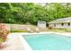 Relaxing poolside view with lounge chairs and stone retaining wall for an outdoor escape at 1662 Rainier Falls Ne Dr, Atlanta, GA 30329