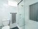 Modern bathroom with gray and white tile shower, glass door, and built in shelf at 1662 Rainier Falls Ne Dr, Atlanta, GA 30329