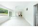 The airy sun room offers tile floors, white trim, sliding doors to backyard and access to the main house at 1662 Rainier Falls Ne Dr, Atlanta, GA 30329