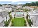 Picturesque aerial image showcases a lush lawn, mature trees, a sparkling pool and elegant architecture at 316 S Esplanade, Alpharetta, GA 30009