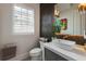 Modern bathroom with a sleek vanity, stylish mirror, and decorative plant accents at 316 S Esplanade, Alpharetta, GA 30009