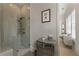 Modern bathroom with a glass-enclosed shower and elegant vanity with drawers at 316 S Esplanade, Alpharetta, GA 30009