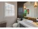 Stylish bathroom with a modern vanity, vessel sink, and decorative wall tiles at 316 S Esplanade, Alpharetta, GA 30009