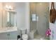 Modern bathroom featuring a glass-enclosed shower, neutral tile, and stylish fixtures at 316 S Esplanade, Alpharetta, GA 30009