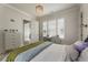 Charming bedroom with ample natural light, complemented by a modern chandelier at 316 S Esplanade, Alpharetta, GA 30009