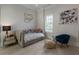 Bright bedroom with daybed, contemporary artwork, shuttered window, and minimalist accents at 316 S Esplanade, Alpharetta, GA 30009