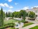 Well-maintained dog park with green turf, shaded areas, and fencing in community at 316 S Esplanade, Alpharetta, GA 30009