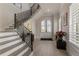Bright foyer with hardwood floors, grand staircase, and elegant arched doorway at 316 S Esplanade, Alpharetta, GA 30009