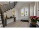 Bright foyer with hardwood floors, grand staircase, and elegant arched doorway at 316 S Esplanade, Alpharetta, GA 30009