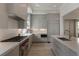 Bright kitchen features stainless steel appliances, grey cabinets, and light hardwood floors at 316 S Esplanade, Alpharetta, GA 30009