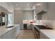 Bright, open kitchen features gray cabinets, stainless appliances, and a large island with a sink at 316 S Esplanade, Alpharetta, GA 30009