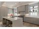 Bright, open kitchen features gray cabinets, stainless appliances, and a large island with seating at 316 S Esplanade, Alpharetta, GA 30009