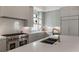 Bright kitchen features stainless steel appliances, grey cabinets, and large island at 316 S Esplanade, Alpharetta, GA 30009