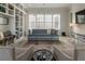Comfortable living room with a built-in bookcase, cozy sofa, and plantation-shuttered windows at 316 S Esplanade, Alpharetta, GA 30009