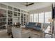 Stylish living area with a full wall bookcase, plush seating, and abundant natural light at 316 S Esplanade, Alpharetta, GA 30009