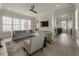Bright living room with large windows, comfortable seating, and a modern ceiling fan at 316 S Esplanade, Alpharetta, GA 30009