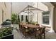 Outdoor patio with full dining table, outdoor kitchen and water feature at 316 S Esplanade, Alpharetta, GA 30009