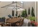 Outdoor dining and kitchen area with grill, patio seating and lush plants at 316 S Esplanade, Alpharetta, GA 30009