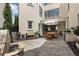 Beautiful outdoor patio with stone flooring, a fountain, and covered dining area with a built-in grill at 316 S Esplanade, Alpharetta, GA 30009