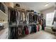 Bright walk-in closet with built-in shelving, drawers and storage space, illuminated by natural light from a window at 316 S Esplanade, Alpharetta, GA 30009