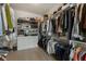 Spacious walk-in closet with custom shelving, drawers and ample hanging space for clothes and accessories at 316 S Esplanade, Alpharetta, GA 30009