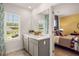 Bathroom view, with double sink vanity and an adjacent bedroom beyond at 319 Elgin Dr # 156, Lawrenceville, GA 30045