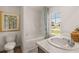 Bathroom featuring a bathtub, toilet, and single vanity with a beautiful exterior view at 319 Elgin Dr # 156, Lawrenceville, GA 30045