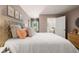 This bedroom has neutral colored walls, carpeted floors, and a view to the bathroom at 319 Elgin Dr # 156, Lawrenceville, GA 30045