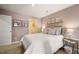 The bedroom features neutral colored walls, carpeted floor, and art work on the walls at 319 Elgin Dr # 156, Lawrenceville, GA 30045