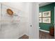 Hall closet leading to half-bathroom with shelving for organized storage at 319 Elgin Dr # 156, Lawrenceville, GA 30045