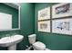 Stylish half-bathroom featuring a modern sink, toilet, and decorative artwork at 319 Elgin Dr # 156, Lawrenceville, GA 30045