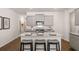 A modern kitchen featuring grey cabinets, stainless steel appliances, and a large island at 319 Elgin Dr # 156, Lawrenceville, GA 30045