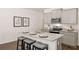Modern kitchen with gray cabinets, granite countertops, stainless steel appliances, and an island with seating at 319 Elgin Dr # 156, Lawrenceville, GA 30045