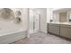 Sleek main bathroom features a double sink vanity, separate shower, and a luxurious soaking tub at 319 Elgin Dr # 156, Lawrenceville, GA 30045