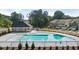 Community pool featuring a large pool deck and a covered shelter for residents to enjoy, with townhomes nearby at 319 Elgin Dr # 156, Lawrenceville, GA 30045