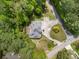 Aerial shot of a house with a large driveway surrounded by lush trees and greenery at 5302 Greenway Dr, Villa Rica, GA 30180