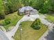 Aerial view of a large home with a circular driveway, manicured lawns, and mature trees at 5302 Greenway Dr, Villa Rica, GA 30180