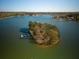 Aerial view of a wooded island with a dock on a calm lake at 5302 Greenway Dr, Villa Rica, GA 30180