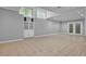 Spacious basement area featuring neutral tile flooring, storage, and access to the outside at 5302 Greenway Dr, Villa Rica, GA 30180
