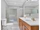Bathroom with tiled shower-tub, wood cabinets, and double vanity at 5302 Greenway Dr, Villa Rica, GA 30180