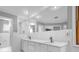 Modern bathroom with double vanity, large mirror, white marble tile, recessed lighting, and glass shower at 5302 Greenway Dr, Villa Rica, GA 30180