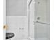Close up of glass enclosed shower featuring white marble tile and gold fixtures at 5302 Greenway Dr, Villa Rica, GA 30180
