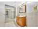 Bathroom with tiled walls, glass enclosed shower-tub, and wooden vanity at 5302 Greenway Dr, Villa Rica, GA 30180