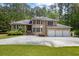 Stately brick home with a three-car garage and well-manicured landscaping provides elegant curb appeal at 5302 Greenway Dr, Villa Rica, GA 30180