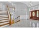 Bright foyer features tile flooring, beautiful staircase, and a front door with decorative glass at 5302 Greenway Dr, Villa Rica, GA 30180