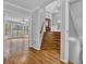 Inviting foyer features hardwood floors, stairs, and view to living room with large windows at 5302 Greenway Dr, Villa Rica, GA 30180