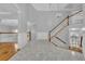 Bright foyer with tile flooring, hardwood staircase, and elegant chandelier at 5302 Greenway Dr, Villa Rica, GA 30180
