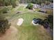 Aerial view of the pristine golf course with lush green fairways and sand traps at 5302 Greenway Dr, Villa Rica, GA 30180